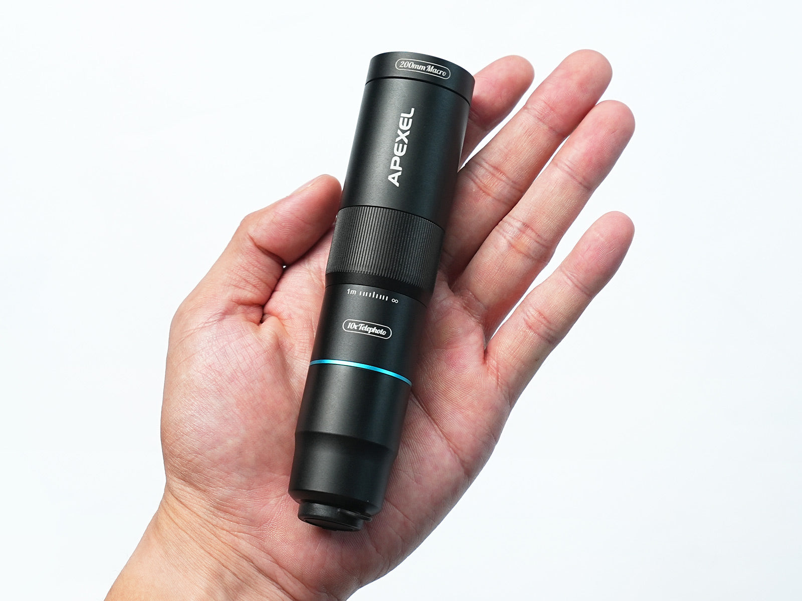 Apexel TeleMacro Pro 10X held in a hand against a white background